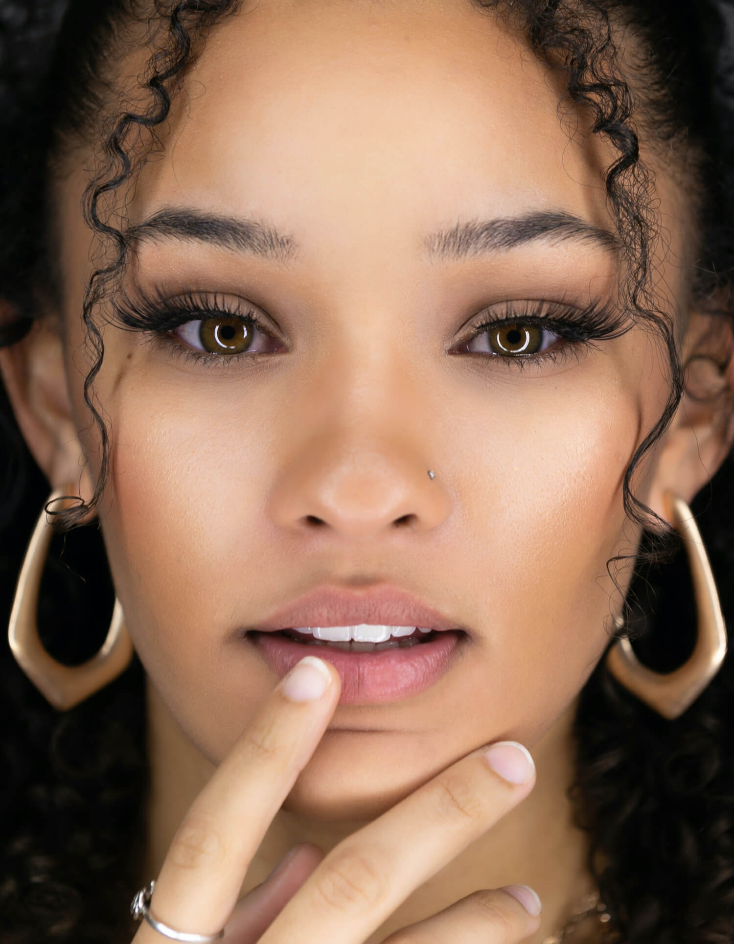 Image of a woman with pink lips and black hair