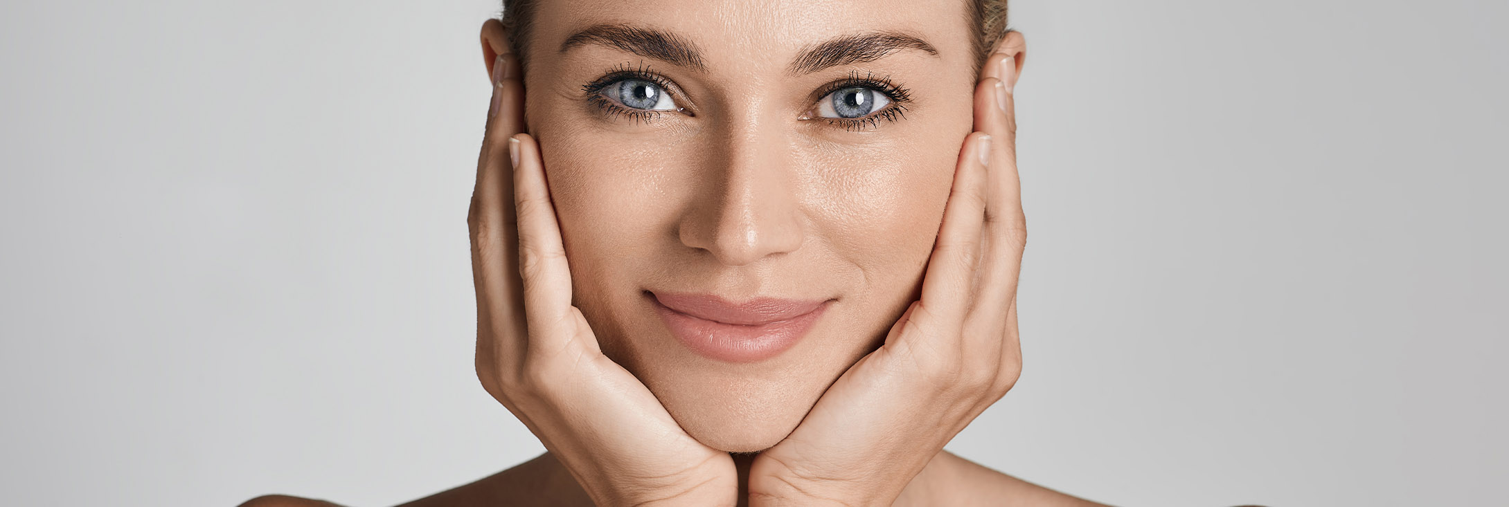 Photo of a blue-eyed woman with wrinkle-free skin