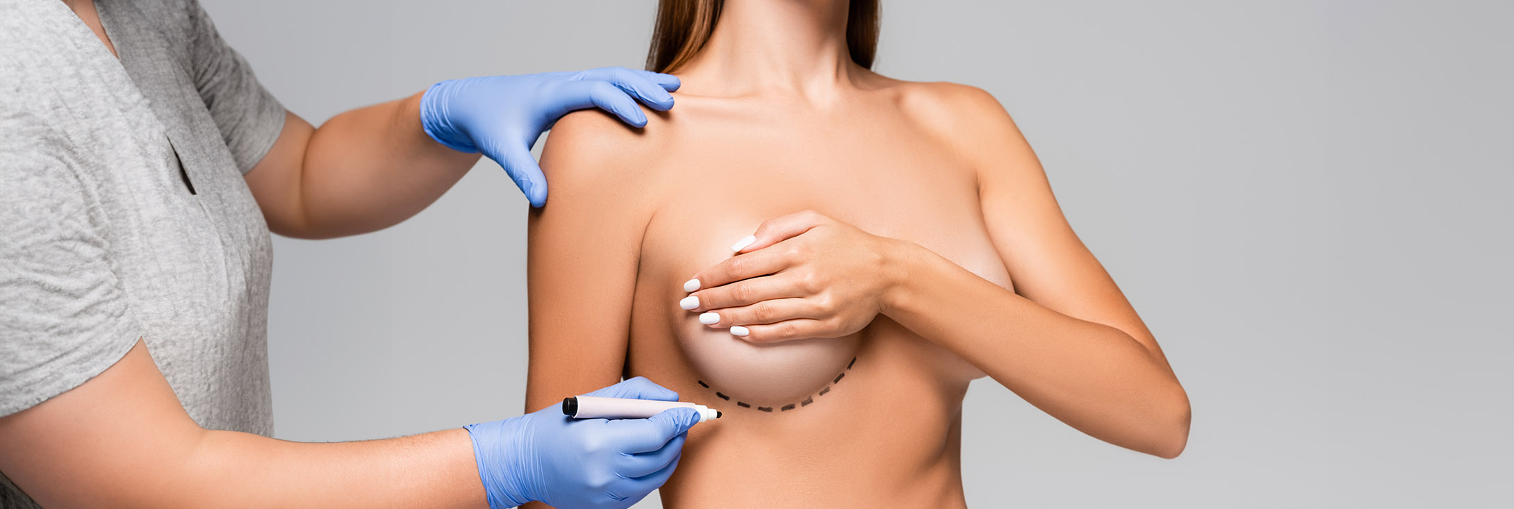 Photo of a woman meeting with her surgeon for a breast augmentation with a lift procedure