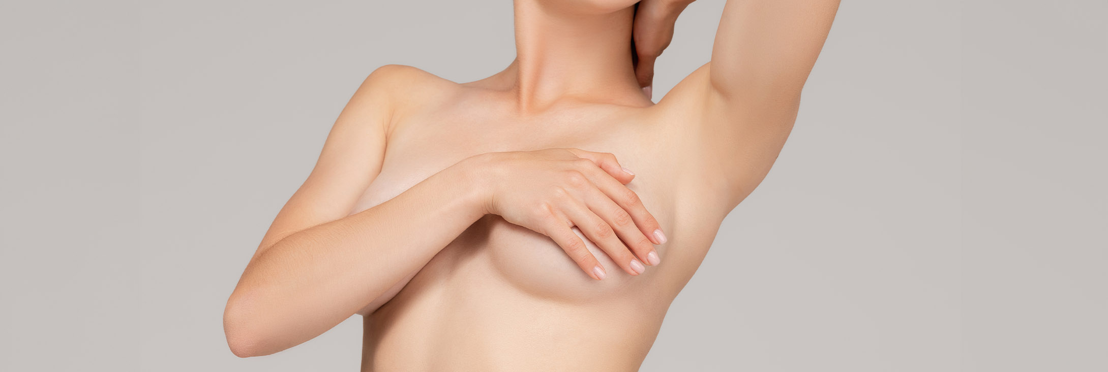 Photo of a woman covering her breasts with her arms