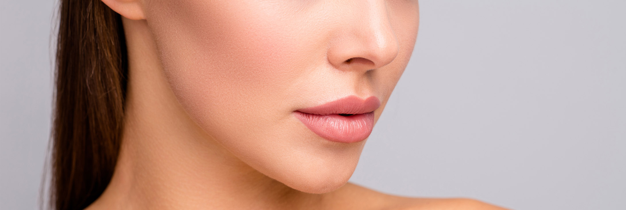 Photo of a woman's lower face and full lips after injectable fillers