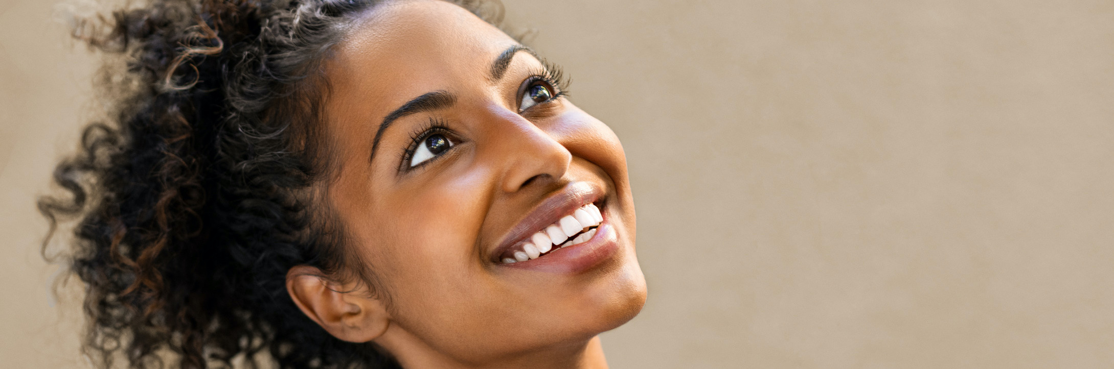 Photo of a woman with big eyes and a big smile