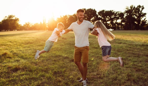 Photo of a man playing with his kids